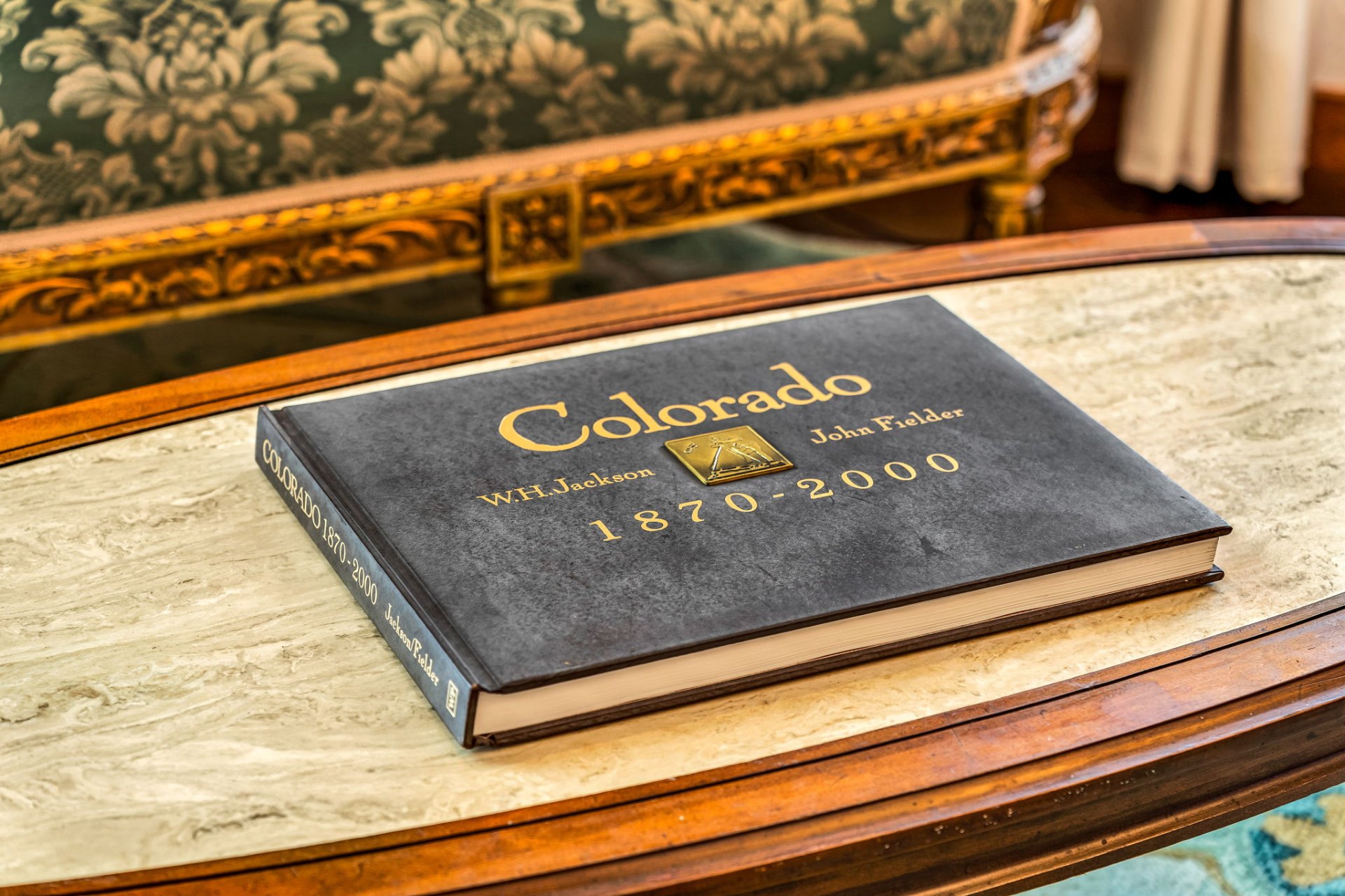Colorado photography book on an antique marble table