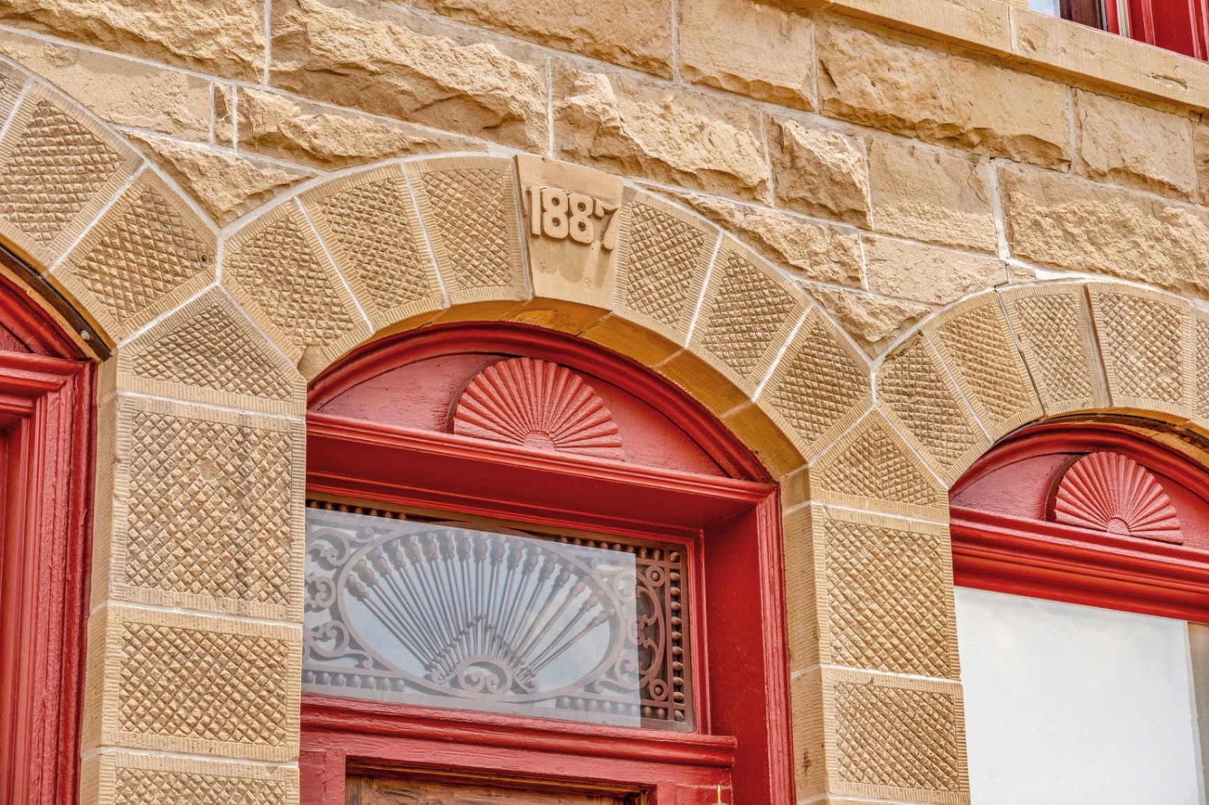 1887 carved stonework and red entrance detail of the Wolff Building