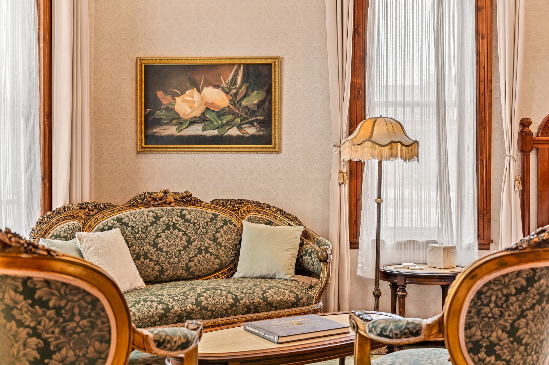 Victorian parlor with damask sofa and gilt frames